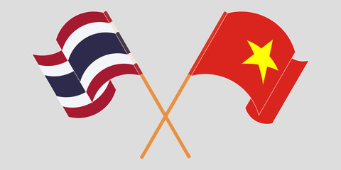 Crossed and waving flags of Thailand and Vietnam