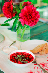 Vegetable cold soup with beets. Cold borscht on hot days. Ingredients of cold soup: quail eggs, green onions, cucumber, dill, radish. beetroot soup. food in nature