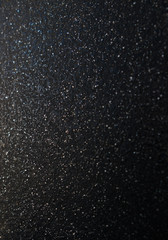 Black sandpaper to make a background image.black glitter texture christmas abstract background