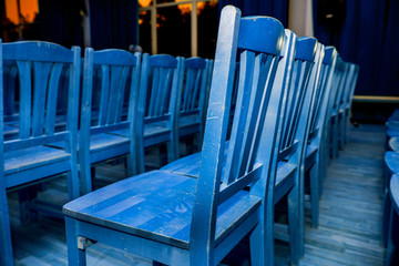 Blue chairs stand in a row in the hall
