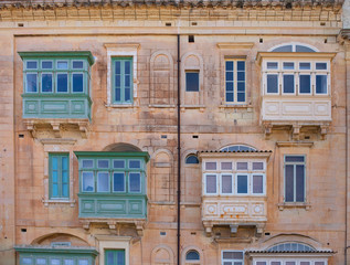 colorful windows and balcony in an old house in Valetta, Malta - 314745051