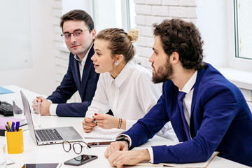 young business people have successful interaction, diverse ladies and guys in formal wear sharing experience, debate new business project sitting in light business room