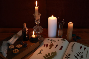 magic ritual of the alchemist with candles, runes and symbols