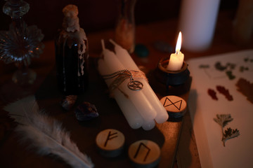 magic ritual of the alchemist with candles, runes and symbols