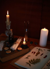 magic ritual of the alchemist with candles, runes and symbols