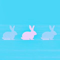 Three pink gradient Easter bunny on an aqua color turquoise background. Happy Easter