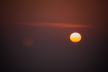 the red sun sets in a gray-pink haze. winter landscape