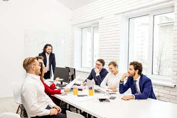 young caucasian people gathered in office to discuss business projects and ideas, wearing formal wear isolated in modern office. diverse enthusiastic people in boardroom