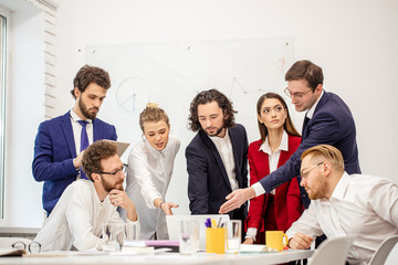 young business people have successful interaction, diverse ladies and guys in formal wear sharing experience, debate new business project sitting in light business room