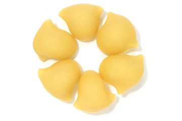 A lot of italian's raw pasta(macaroni) conchiglie on a white background