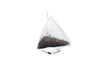 tea bag of black tea with herbs on a white isolated background