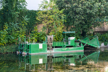 An aquatic weed harvester on a lake.