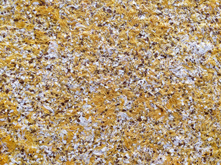 Liquid wallpaper with embossed pattern texture. Yellow cellulose wallpaper with decorative elements. A popular type of coating for walls and ceilings.
