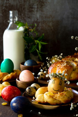 Easter pastries background. Colored eggs on a wooden table. Copy space.