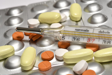 medicine pills with fever thermometer. concept image