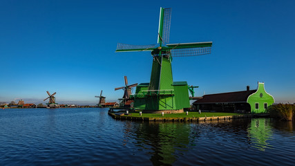 Fototapeta na wymiar Netherlands - Multiple Windmills Shot From Water