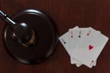 Top view of Judge's gavel and playing cards. Concept of Law and regulation of gambling