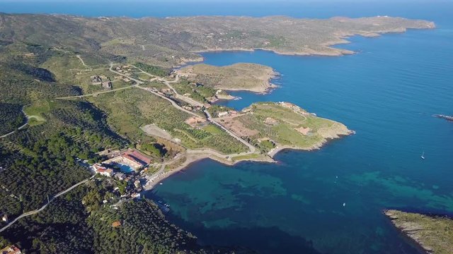 Cadaques amazing spanish town by the sea. Punta de sa Costa. Video footage. Aerial drone camera moves away from the beach at sea. view to mountains landscape and the city