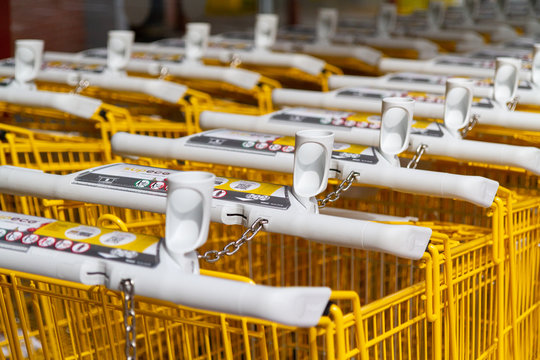 Valenciennes, France. 2019/9/9. Rows of yellow branded shopping trolleys (carts) at a supermarket in France.