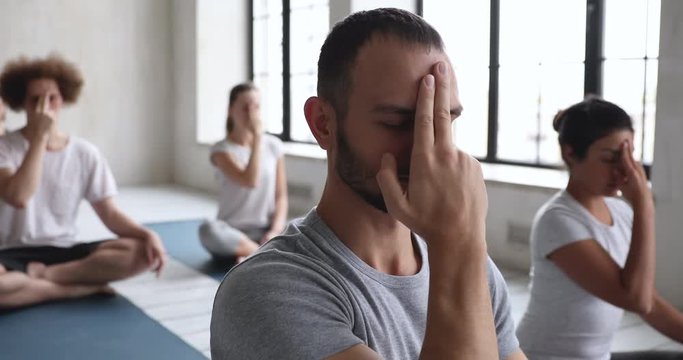 Group of multiracial people do opening the third eye meditation