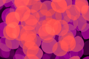 Abstract orange and violet color blurred lights background. Festive defocused bokeh background