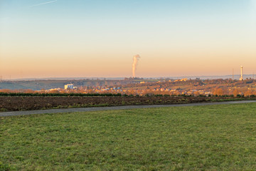 Obraz premium Landscape with nuclear power plant Column of smoke in the background at sunset