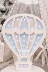 Fototapeta na wymiar Beautiful wooden eco-friendly night light with led bulbs in the shape of a balloon, children's room decor