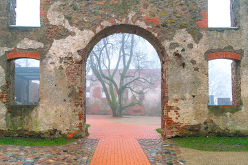 The ancient castle of the Livonian Order in dense fog.
