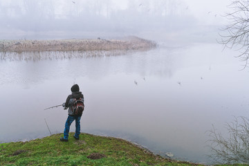 In the thick fog, a fisherman