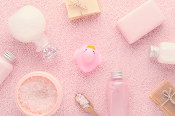 Fototapeta na wymiar natural products for bath, pink salt, handmade soap and foam on pink background