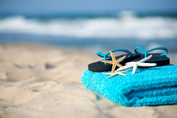 Summer vacation concept  towel with sunglasses and starfish on sandy tropical beach - selective focus, copy space