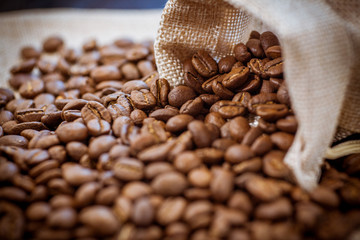 Roasted coffee beans in a bag. Brown coffee beans, of coffee beans for background and texture. Beans of roasted black coffee. Background.