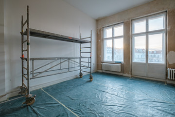 empty room during renovation with scaffolding - home refurnishment -