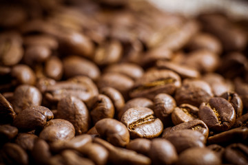 Premium quality light roasted coffee beans rotating. Close up of brown roasted coffee beans