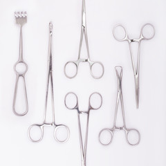 Close-up of stainless steel surgical instruments on white background