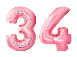 Number 34 thirty four made of rose gold inflatable balloons isolated on white background. Pink...