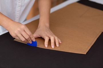 Close up portrait of fashion designer working in sewing studio.