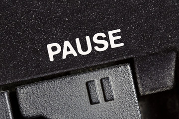 Macro close up photograph of vintage tape machine play and record pause button.  
