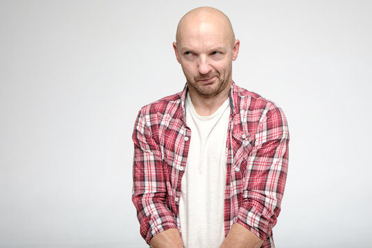Bald man is guilty. He looks away from bashfulness and embarrassment. Copy space.