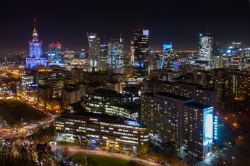 Fototapeta na wymiar Warsaw, Poland. 03. December. 2019. Drone shot at night metropolis with skyscrapers and buildings. Aerial view of the business center at night in winter. Warsaw,