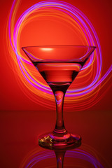 a glass of martini on a red background