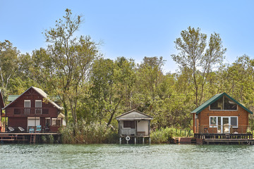 Fototapeta na wymiar Fishermen's huts on a river bank