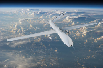 military RC military drone flies flies against backdrop of beautiful clouds on blue sky background....
