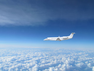 Fototapeta na wymiar White private jet business jet flies against backdrop of beautiful white clouds on blue sky