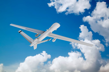 military RC military drone flies flies against backdrop of beautiful clouds on blue sky background.