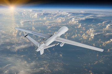military RC military drone flies flies against backdrop of beautiful clouds on blue sky background....