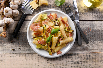Tasty rigatoni pasta with courgette, prosciutto ham and grana padano cheese