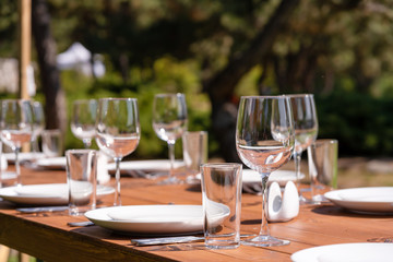 Served wooden table without a tablecloth. Cafe in the open air park