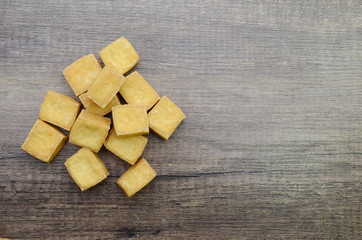 fried tofu on wooden background