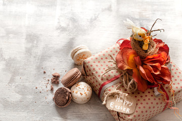 Easter gift and sweets on a wooden background.